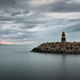 Faro de Levante Lighthouse on Stone Breakwater at Benalmadena Puerto Marina Faro de Levante Lighthouse on Stone Breakwater at Benalmadena Puerto Marina - PhotoDune Item for Sale