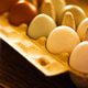 Assorted eggs in a cardboard carton on a wooden surface Assorted eggs in a cardboard carton on a wooden surface - PhotoDune Item for Sale