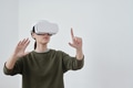 Young contemporary female employee pointing at object in virtual reality Young contemporary female employee pointing at object in virtual reality - PhotoDune Item for Sale