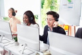 Team of helpline operators with headsets consulting clients at call center Team of helpline operators with headsets consulting clients at call center - PhotoDune Item for Sale