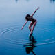 Woman in a swimsuit gracefully dancing on water making ripples in a serene lake setting. WA, USA Woman in a swimsuit gracefully dancing on water making ripples in a serene lake setting. WA, USA - PhotoDune Item for Sale
