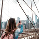 Woman capturing Manhattan skyline from Brooklyn Bridge Woman capturing Manhattan skyline from Brooklyn Bridge - PhotoDune Item for Sale