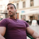 Attractive man looking around waiting girlfriend while sitting in the cafe outdoors Attractive man looking around waiting girlfriend while sitting in the cafe outdoors - PhotoDune Item for Sale