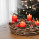 Advent wreath made of branches with four candles burning on Christmas Eve. Hygge time at home. Advent wreath made of branches with four candles burning on Christmas Eve. Hygge time at home. - PhotoDune Item for Sale