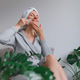 Young happy woman in dressing gown making face massage after bath. Hairs wrapped in bath towel Young happy woman in dressing gown making face massage after bath. Hairs wrapped in bath towel - PhotoDune Item for Sale