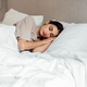 Young woman sleeping in comfortable bed at home, healthy rest and relaxation Young woman sleeping in comfortable bed at home, healthy rest and relaxation - PhotoDune Item for Sale