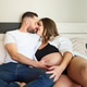 Expecting couple showing intimacy in bed Expecting couple showing intimacy in bed - PhotoDune Item for Sale