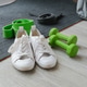 white sports shoes, dumbbells, fitness rubber bands, on a black sports mat white sports shoes, dumbbells, fitness rubber bands, on a black sports mat - PhotoDune Item for Sale
