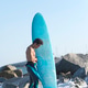 Back view of young surfer standing barefooted on sandy shore, Back view of young surfer standing barefooted on sandy shore, - PhotoDune Item for Sale