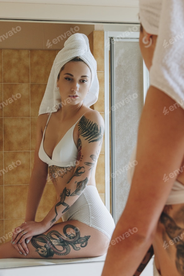 cropped shot of sexy tattooed girl in lingerie and towel looking at mirror in bathroom Stock Photo by LightFieldStudios cropped shot of sexy tattooed girl in lingerie and towel looking at mirror in bathroom Stock Photo by LightFieldStudios