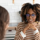 confident curly haired woman with curly dark hair, designer or realtor, shows mock up house. confident curly haired woman with curly dark hair, designer or realtor, shows mock up house. - PhotoDune Item for Sale