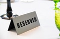 Table at restaurant with reserved sign close-up Table at restaurant with reserved sign close-up - PhotoDune Item for Sale
