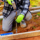 Construction worker using hammer to install stake in ground residential area Construction worker using hammer to install stake in ground residential area - PhotoDune Item for Sale