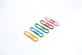 Colored paper clips close-up on a white background Colored paper clips close-up on a white background - PhotoDune Item for Sale