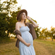 Pregnant woman in summer dress enjoying nature outdoors Pregnant woman in summer dress enjoying nature outdoors - PhotoDune Item for Sale