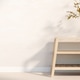 Book and vase on wooden shelf table with a decorative tree branch and sunlight shining on white wall Book and vase on wooden shelf table with a decorative tree branch and sunlight shining on white wall - PhotoDune Item for Sale