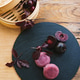 A Purple bamboo steamer filled with cherries is displayed on a wooden table.Mochi asian dessert A Purple bamboo steamer filled with cherries is displayed on a wooden table.Mochi asian dessert - PhotoDune Item for Sale