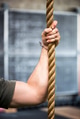 Strong muscular male arm holding a rope Strong muscular male arm holding a rope - PhotoDune Item for Sale