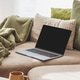 Laptop on Sofa and Coffee Mug on Table. Cozy Spring Home Workspace Laptop on Sofa and Coffee Mug on Table. Cozy Spring Home Workspace - PhotoDune Item for Sale