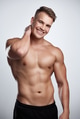 I look good in muscles. Studio portrait of a muscular young man posing against a grey background. I look good in muscles. Studio portrait of a muscular young man posing against a grey background. - PhotoDune Item for Sale
