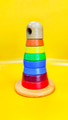 A toy rainbow pyramid on yellow background A toy rainbow pyramid on yellow background - PhotoDune Item for Sale