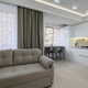 Living room with a couch and a kitchen in the background Living room with a couch and a kitchen in the background - PhotoDune Item for Sale