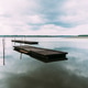 Lake of Soustons reflecting a cloudy sky and wooden docks Lake of Soustons reflecting a cloudy sky and wooden docks - PhotoDune Item for Sale