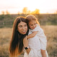 Cute young daughter on a piggy back ride with her mother. Cute young daughter on a piggy back ride with her mother. - PhotoDune Item for Sale