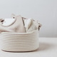 Different sets of newborn clothes in one white rope basket on stone background. Different sets of newborn clothes in one white rope basket on stone background. - PhotoDune Item for Sale