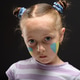 Portrait of an eight-year-old girl with aqua make-up on her cheeks. Concept How long will it last? Portrait of an eight-year-old girl with aqua make-up on her cheeks. Concept How long will it last? - PhotoDune Item for Sale