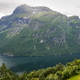 Geirangerfjord in Norway. Fjord is surrounded by majestic mountains, creating picturesque landscape Geirangerfjord in Norway. Fjord is surrounded by majestic mountains, creating picturesque landscape - PhotoDune Item for Sale