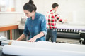 Concentrated woman working in printing office Concentrated woman working in printing office - PhotoDune Item for Sale