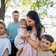 Family portrait featuring a woman holding a toddler surrounded by children Family portrait featuring a woman holding a toddler surrounded by children - PhotoDune Item for Sale
