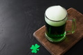 Patrick's day green beer in pint on black background. Patrick's day green beer in pint on black background. - PhotoDune Item for Sale