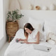 Relaxed woman lying in the bed and using smartphone. Relaxed woman lying in the bed and using smartphone. - PhotoDune Item for Sale