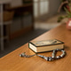 Islamic Prayer Beads and Quran Resting on Wooden Table Indoors Islamic Prayer Beads and Quran Resting on Wooden Table Indoors - PhotoDune Item for Sale