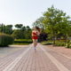 An Energetic Young Woman Running in the Park An Energetic Young Woman Running in the Park - PhotoDune Item for Sale