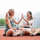 Asian women friends clapping hands high five while sitting on running track resting after exercise. Asian women friends clapping hands high five while sitting on running track resting after exercise. - PhotoDune Item for Sale