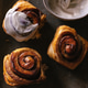 Baked cinnamon bun rolls with white vanilla bean cream frosting. Moody food photo.Closeup flat lay Baked cinnamon bun rolls with white vanilla bean cream frosting. Moody food photo.Closeup flat lay - PhotoDune Item for Sale