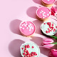 Top view of sponge cake cupcakes with pink and white icing and heart-shaped sugar sprinkles Top view of sponge cake cupcakes with pink and white icing and heart-shaped sugar sprinkles - PhotoDune Item for Sale