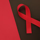 Red ribbon is symbolizing awareness for health issues Red ribbon is symbolizing awareness for health issues - PhotoDune Item for Sale