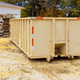 Large waste container located on construction site during works day with wooden pallets nearby Large waste container located on construction site during works day with wooden pallets nearby - PhotoDune Item for Sale