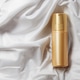 Mock up golden spray bottle for cosmetics on elegant white satin backdrop Mock up golden spray bottle for cosmetics on elegant white satin backdrop - PhotoDune Item for Sale