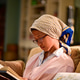 Young girl sitting on the sofa reading a book at night just before bed Young girl sitting on the sofa reading a book at night just before bed - PhotoDune Item for Sale