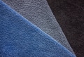 Three terry towels in blue, gray and dark gray colors. Terry bath towels made of cotton close-up. Three terry towels in blue, gray and dark gray colors. Terry bath towels made of cotton close-up. - PhotoDune Item for Sale