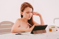 Little girl Preteen sitting sad, using tablet pad, watching online lesson. Online distant education Little girl Preteen sitting sad, using tablet pad, watching online lesson. Online distant education - PhotoDune Item for Sale