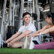 A happy Asian man is enjoying a conversation while warming up with his girlfriend at the gym. A happy Asian man is enjoying a conversation while warming up with his girlfriend at the gym. - PhotoDune Item for Sale