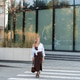 Woman in Brown Dress and White Shirt Crossing the Street at a Crosswalk Near Modern Office Building Woman in Brown Dress and White Shirt Crossing the Street at a Crosswalk Near Modern Office Building - PhotoDune Item for Sale