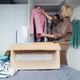 Middle aged woman selecting clothes from wardrobe for donating to Charity shop. Decluttering Middle aged woman selecting clothes from wardrobe for donating to Charity shop. Decluttering - PhotoDune Item for Sale