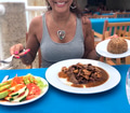 Happy Hispanic Latino woman ready to have a delicious tropical meal in a restaurant on the beach. Happy Hispanic Latino woman ready to have a delicious tropical meal in a restaurant on the beach. - PhotoDune Item for Sale